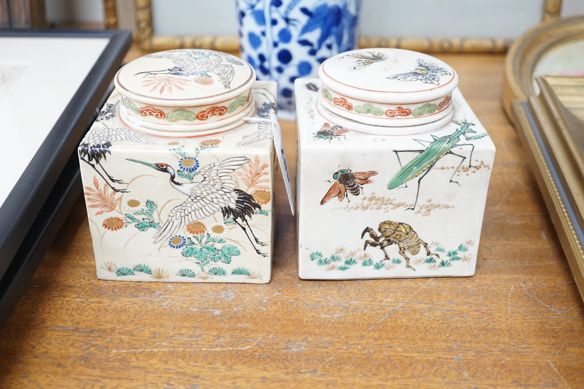 Two Japanese Satsuma boxes and covers, 10cm wide, and a blue and white Chinese vase, 26cms high